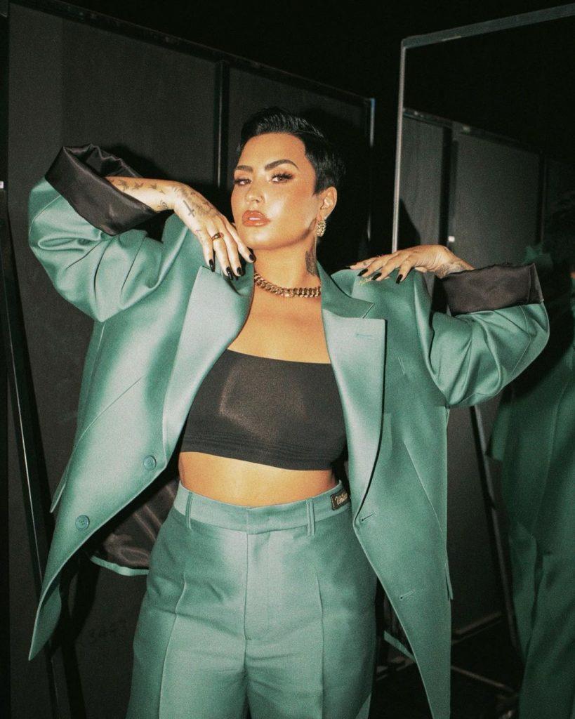 Demi Lovato in a green suit