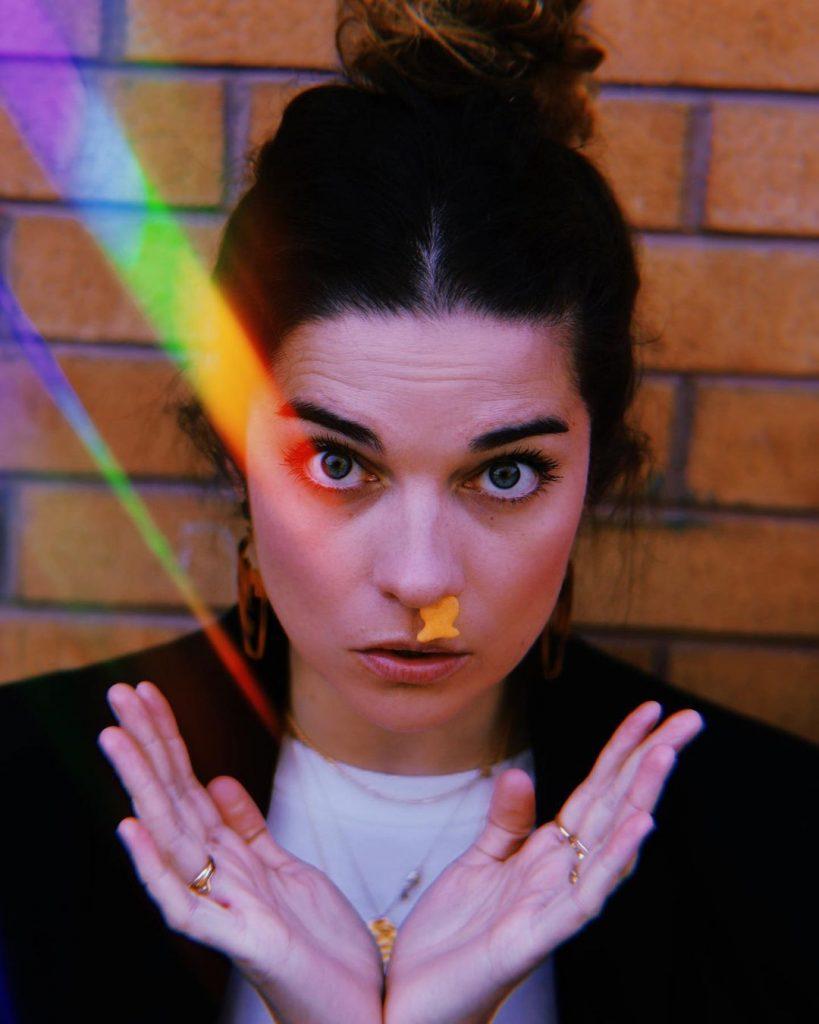 Annie Murphy with a gold fish up her nose