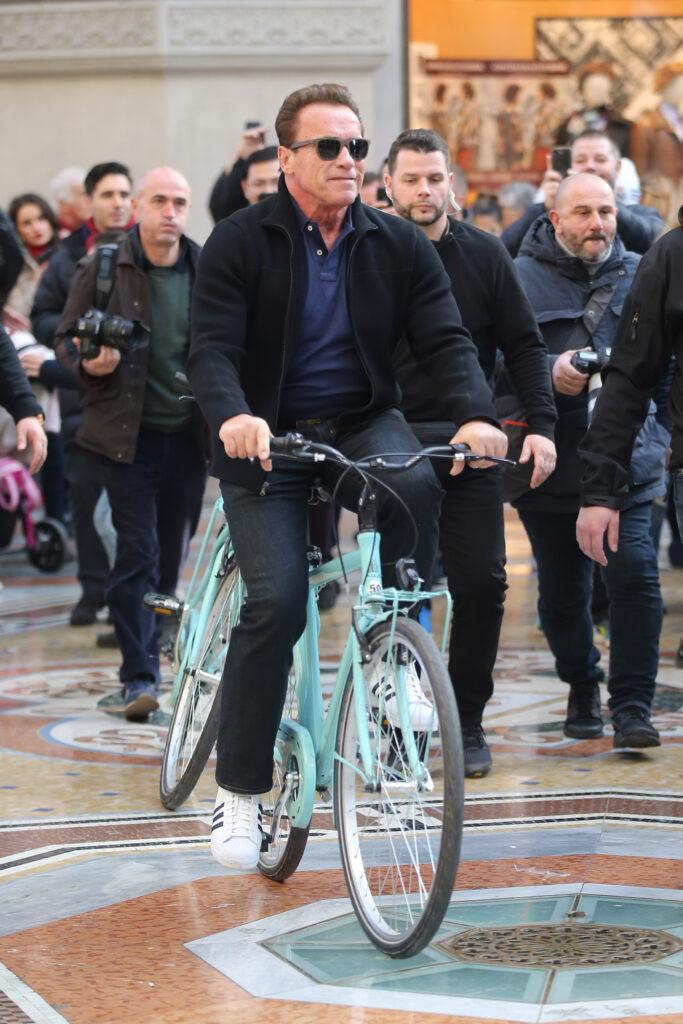 Arnold Schwarzenegger and female friend seen riding bicycles in Milan