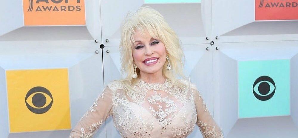 A photo showing Dolly Parton in a shiny dress with a big smile on her face