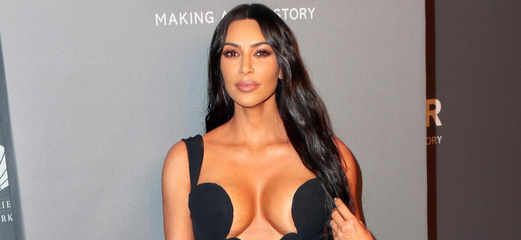 Kim Kardashian flashes her ample cleavage and toned abs in a SKIMS
