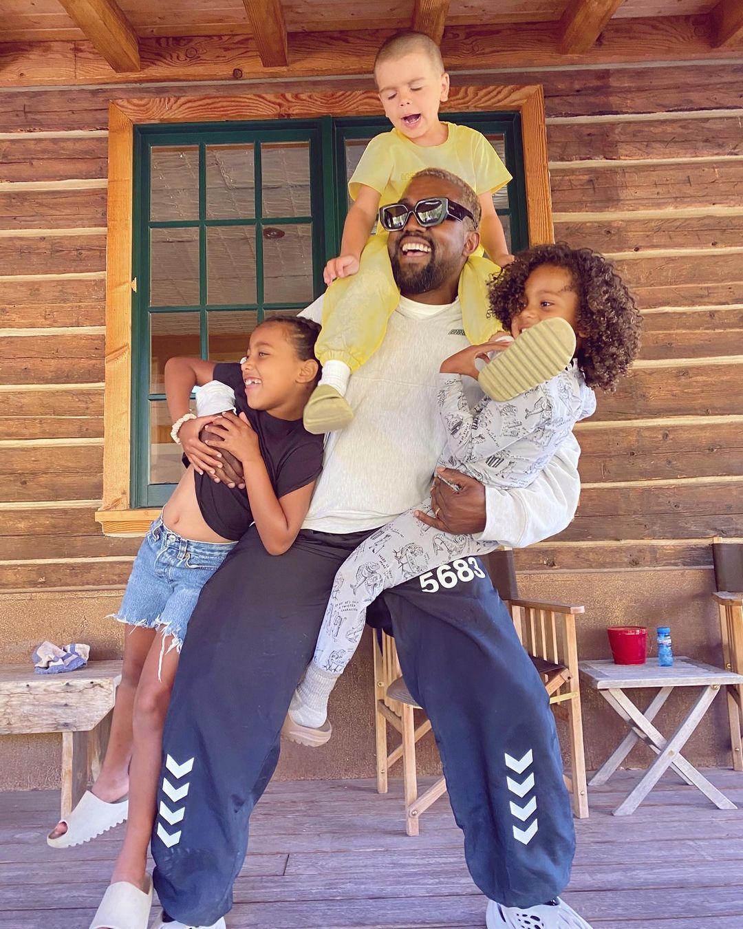 A photo showing Kanye West goofing around with his kids.