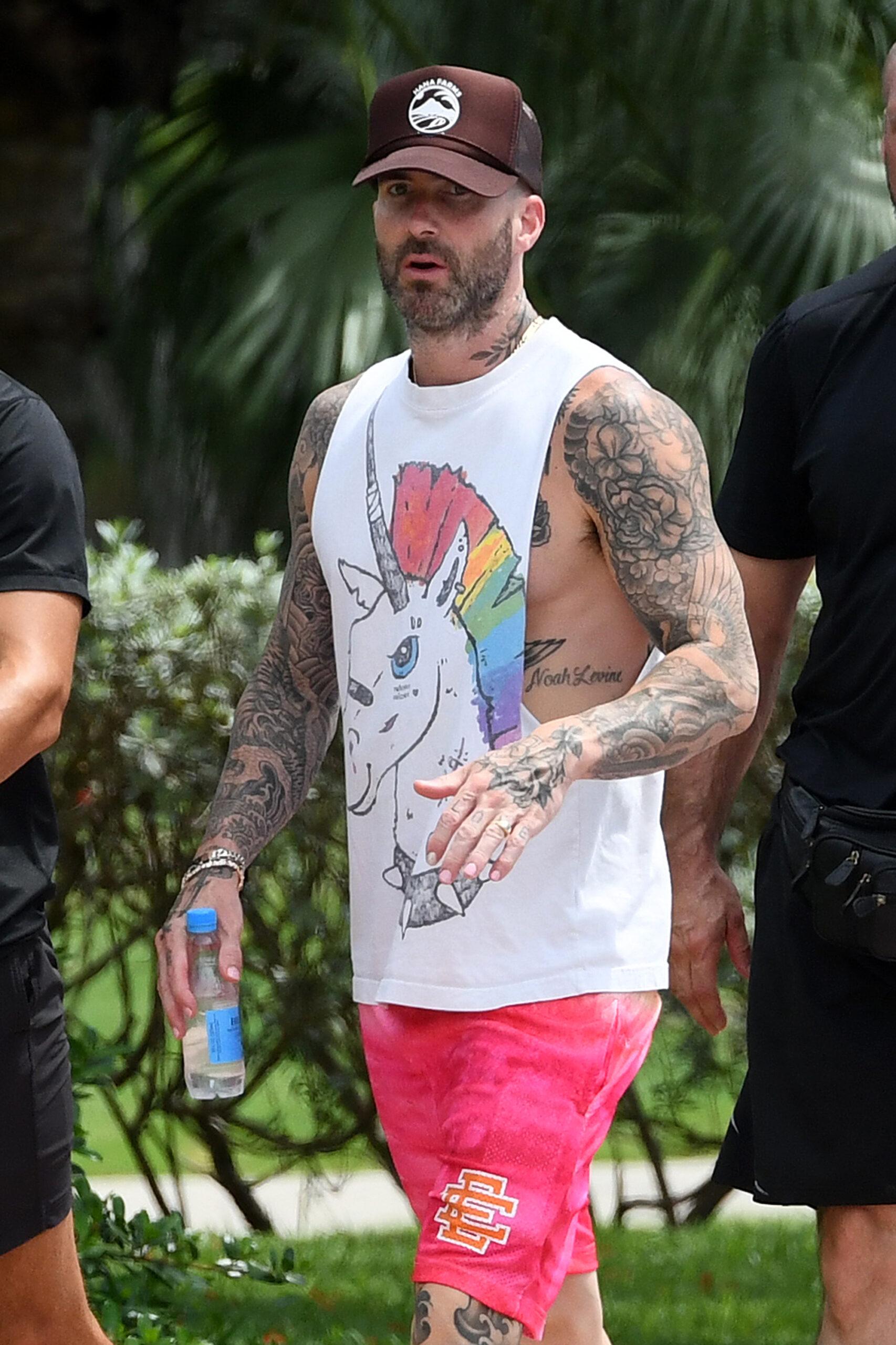 Adam Levine wears a unicorn shirt as he walks with his trainer and bodyguard in Miami