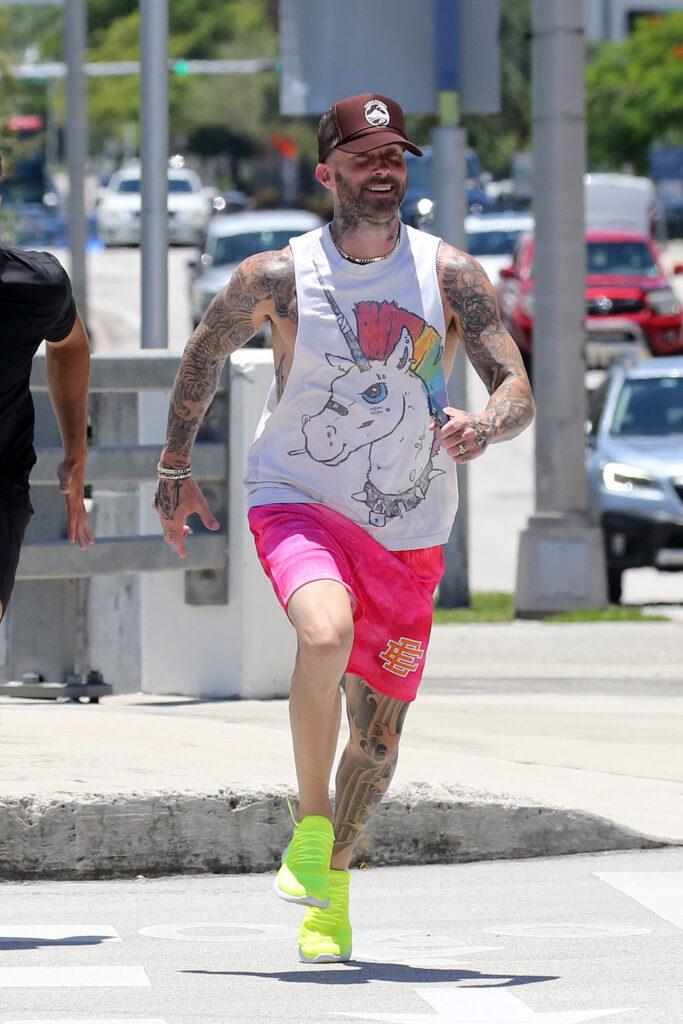 Adam Levine shows of his tattoos and muscles as he works out in Miami