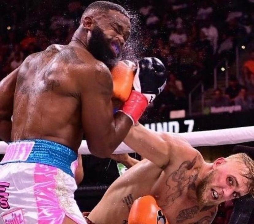 Jake Paul landing a jab on Tyron Woodley, in their boxing match in Cleveland, OH, in August 2021.