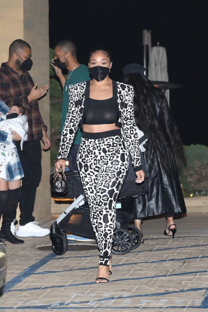 Jordyn Woods shows off her curvy figure in a see through top and animal print outfit as she dines at Nobu Malibu