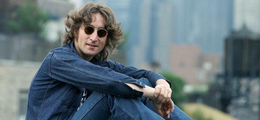 A photo showing John Lennon in a denim pant and jacket.