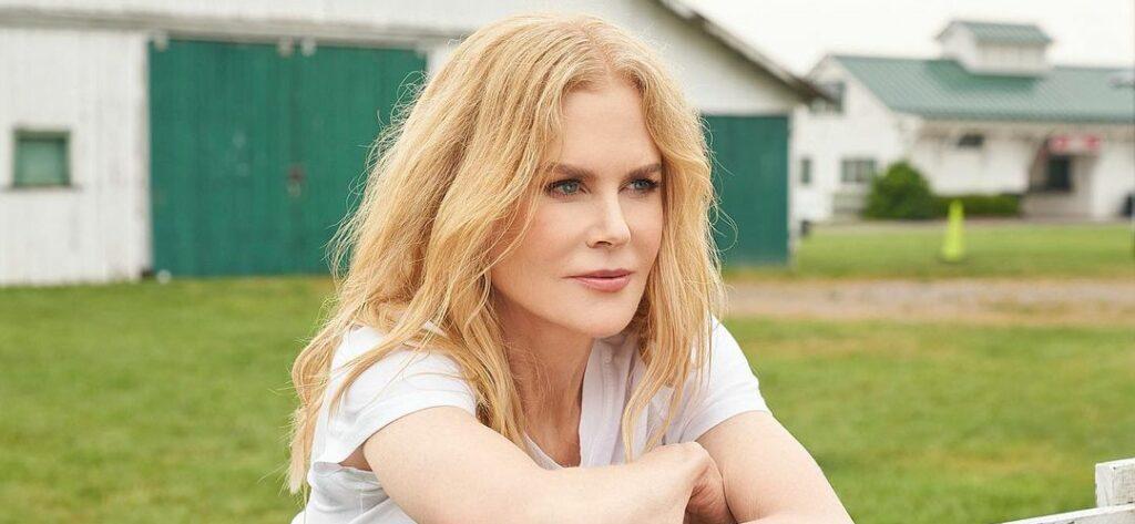 A photo showing Nicole Kidman on a field sporting a white blouse