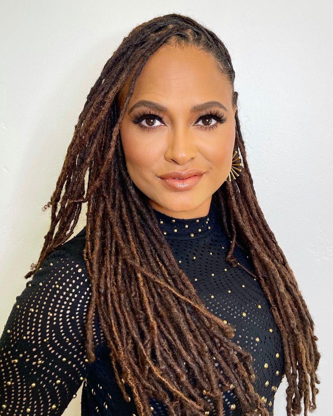 An up-close photo of Ava DuVernay sporting dreads.
