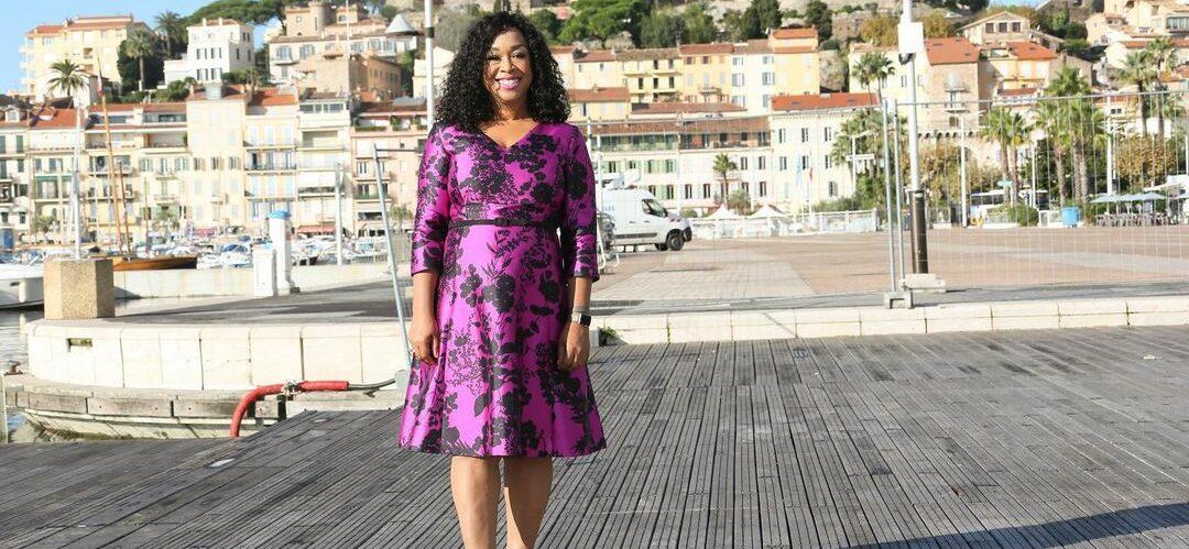 A photo showing Shonda Rhimes outside in a purple dress