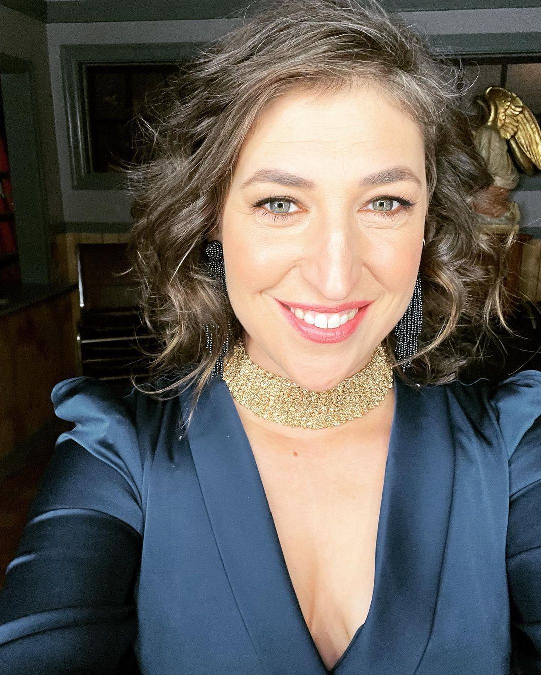 An up-close photo showing Mayim Bialik with a cute smile on her face.