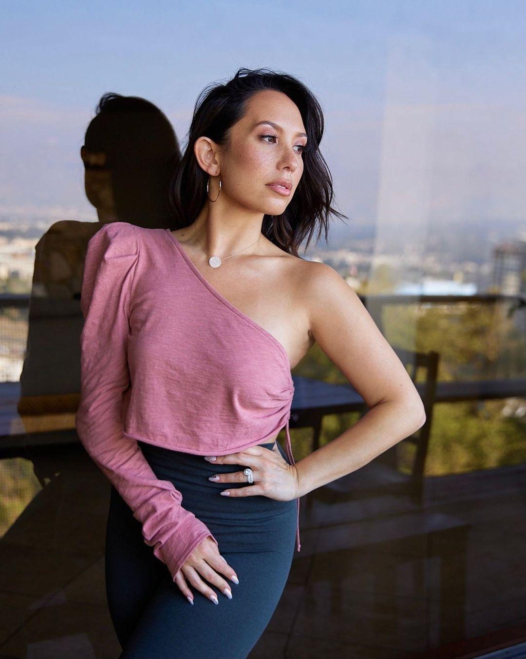 A photo showing Cheryl Burke in a one-shoulder blouse and body-hug skirt.