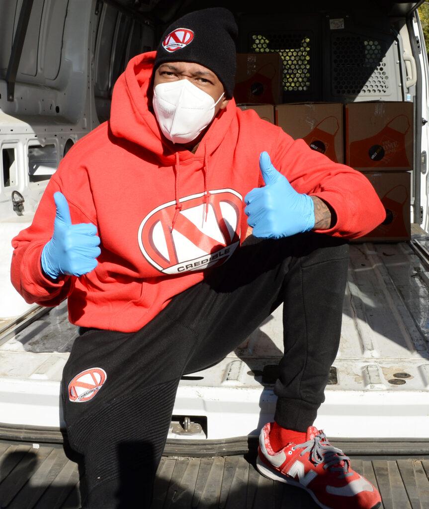 Nick Cannon wearing blue rubber gloves