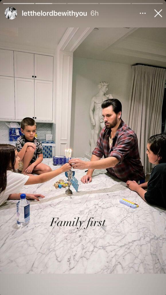 Scott Disick with his kids playing on the kitchen counter.