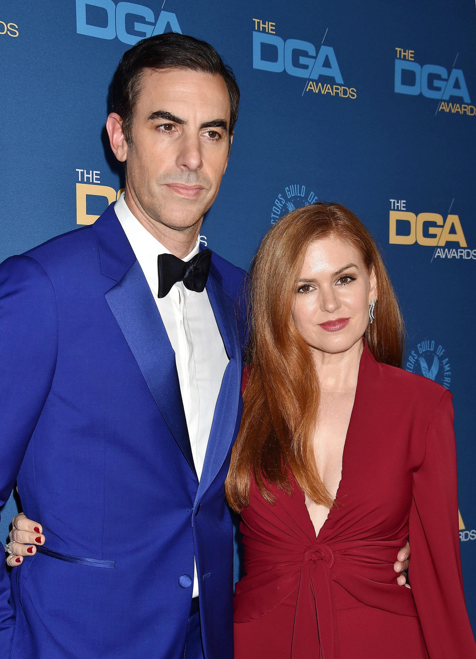 Sacha Baron Cohen and Isla Fisher smiling.