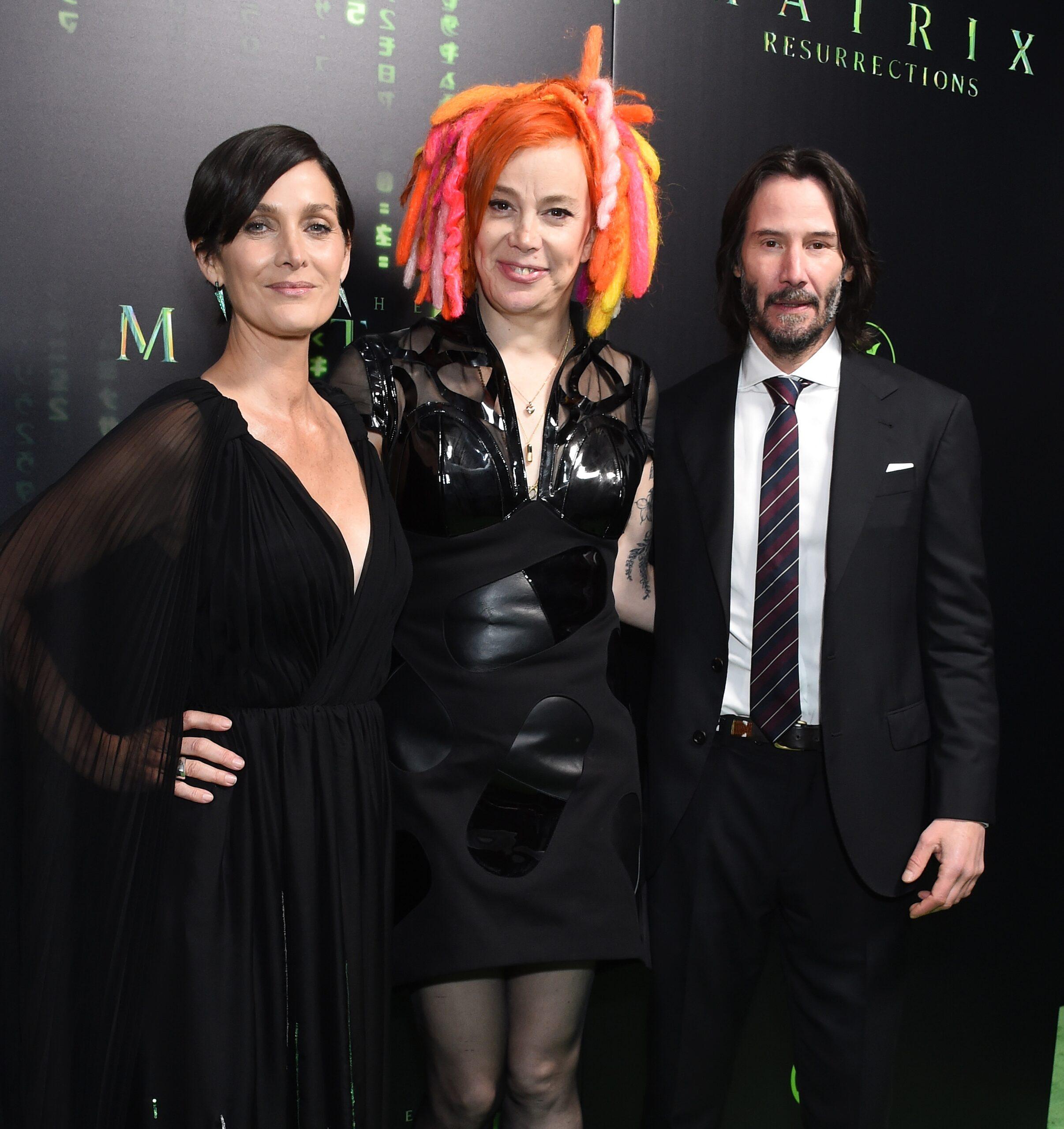 Keanu Reeves and Carrie-Anne Moss posing for the camera.