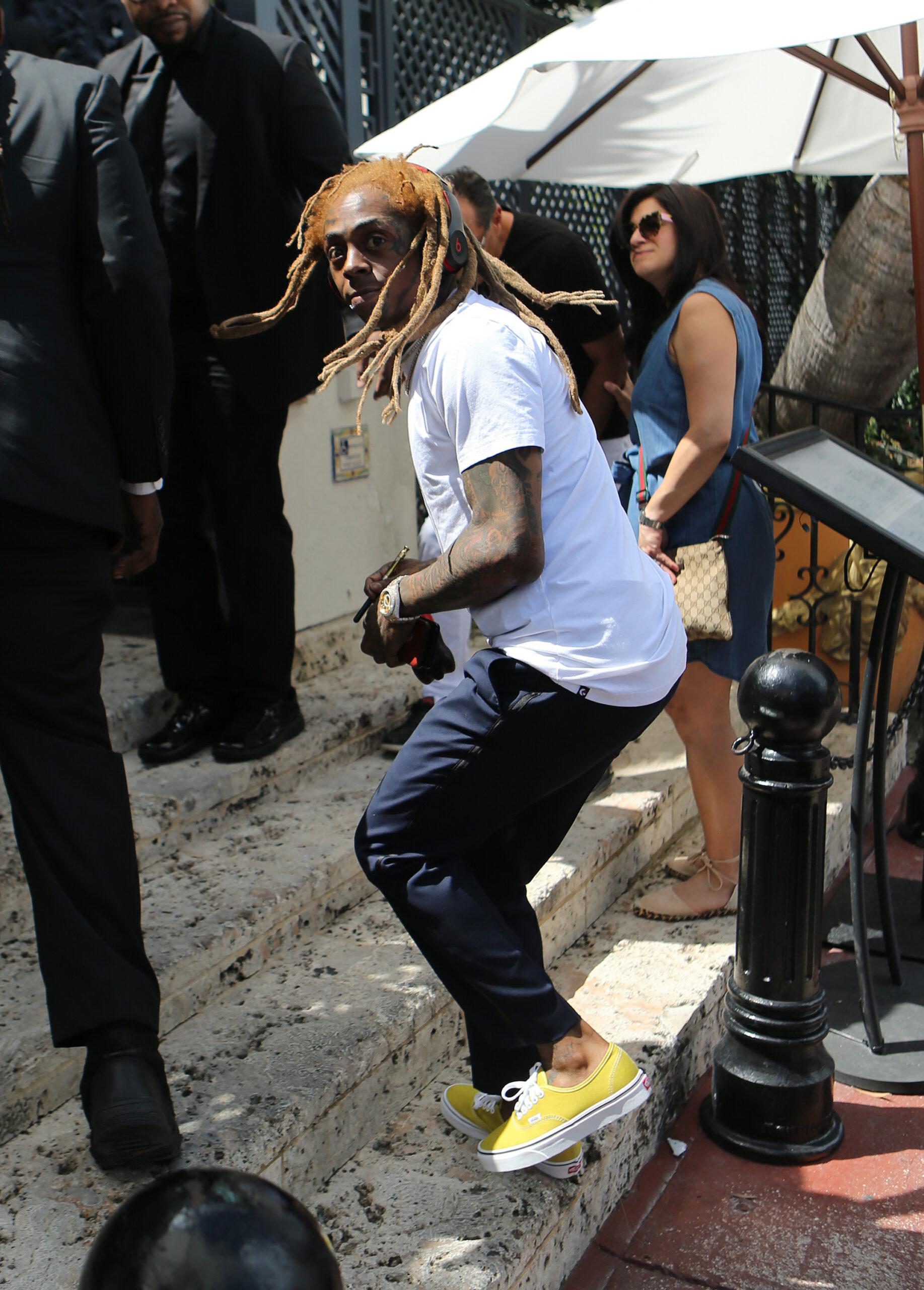 Rapper Lil Wayne sports yellow dreadlocks as he arrives to the wedding of rapper 2 Chainz