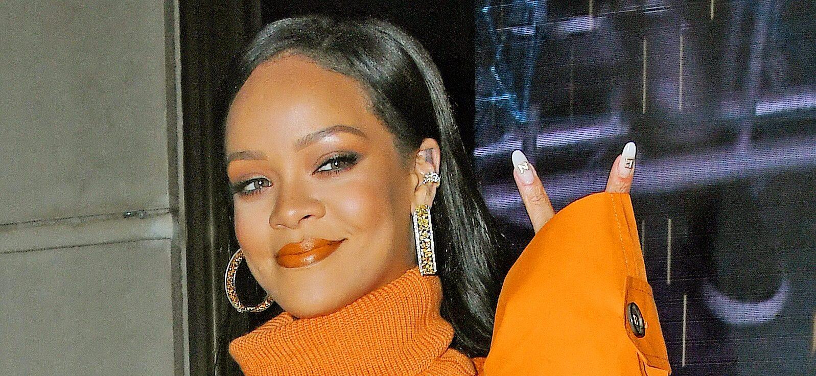 Rihanna stops by Fenty pop-up in an all orange outfit