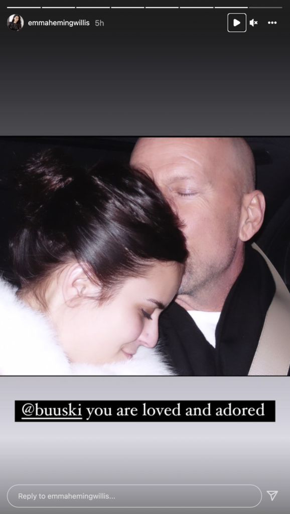 Bruce Willis kissing daughter Tallulah's head.