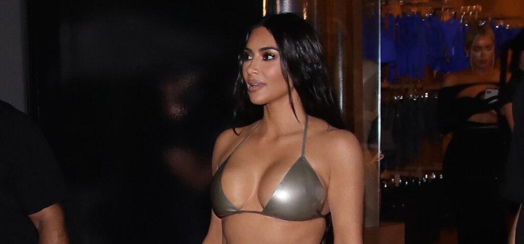 Kim Kardashian waves to her adoring fans as she arrives to her Skims pop up event in bikini top in Miami