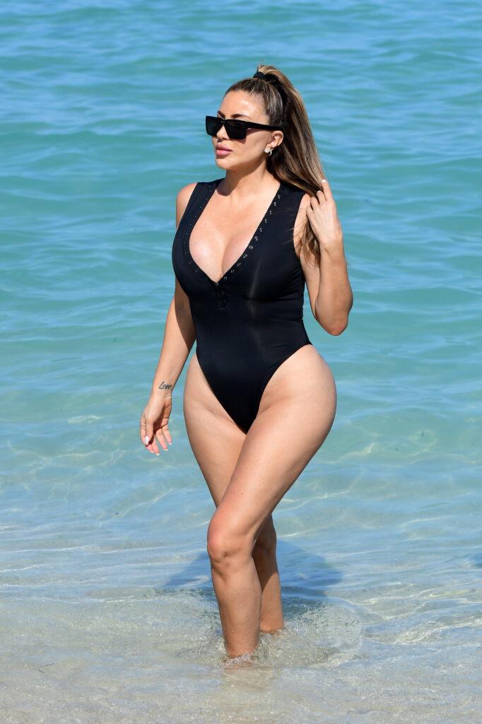 Larsa Pippen shows off her curves in a revealing black one piece as she hits the beach in Miami