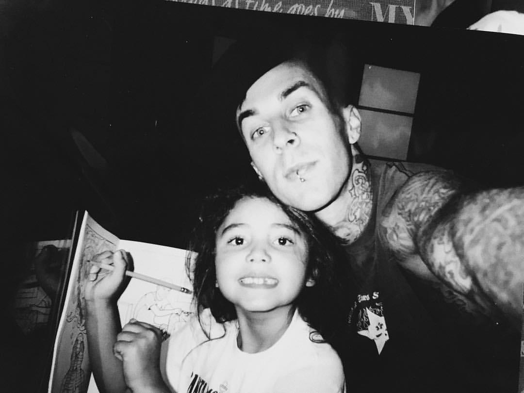 Atiana De La Hoya posing with Travis Barker.