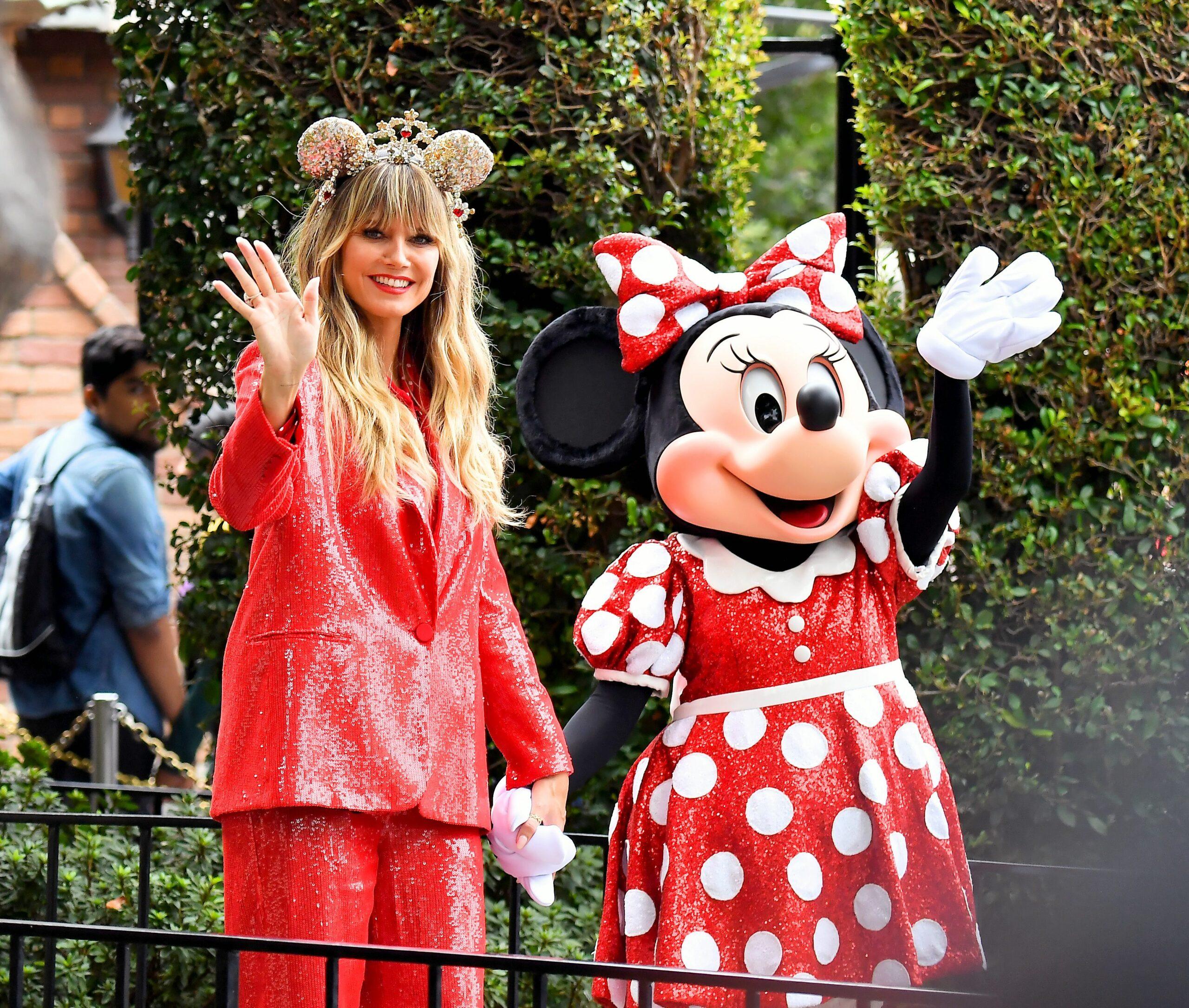 Heidi Klum poses for pictures with Minnie Mouse as she promotes a pair of mickey ears that she designed herself at Disneyland