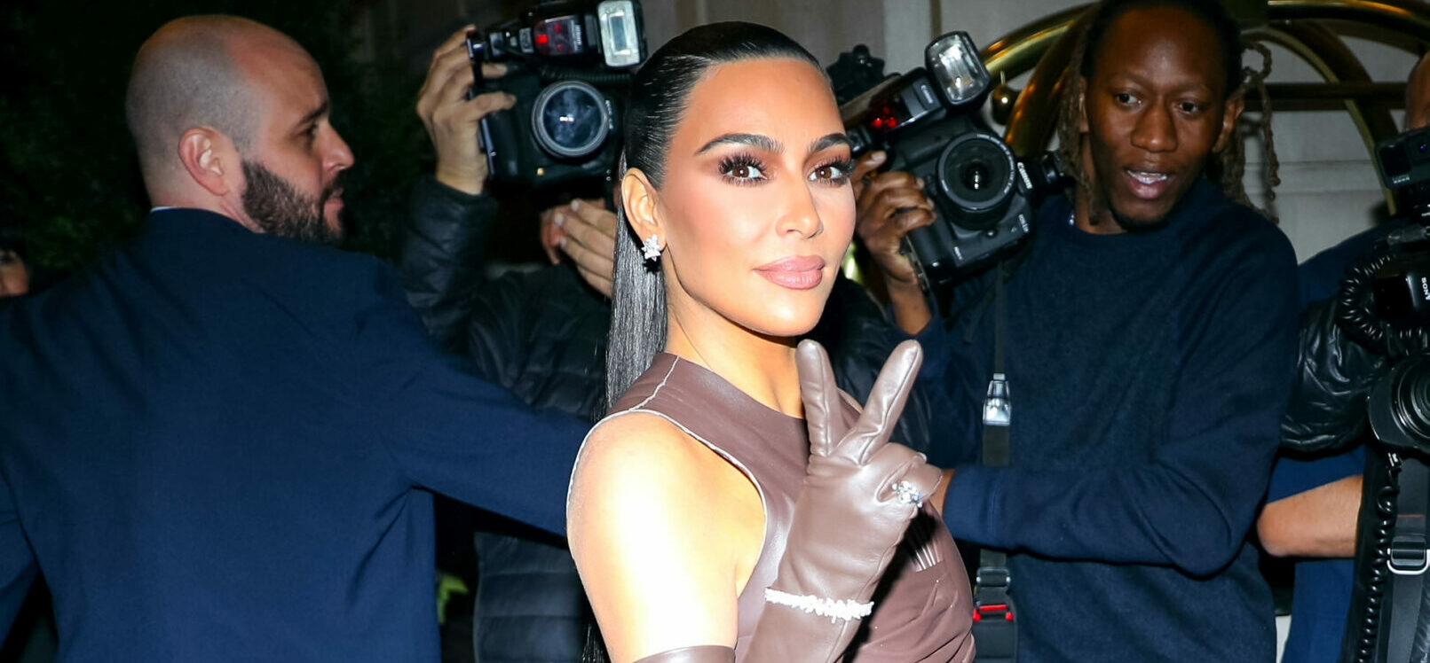 Kim Kardashian flashing a peace sign