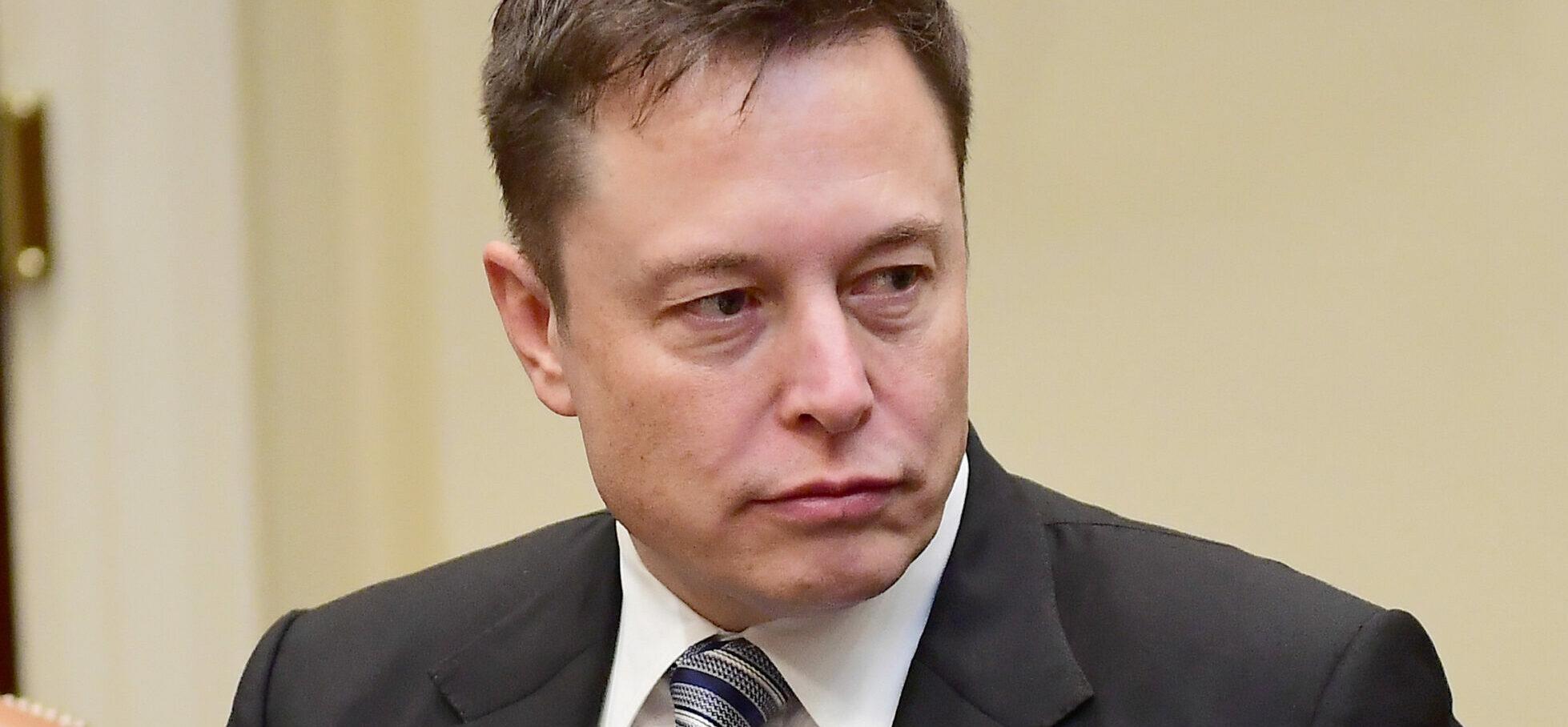 Elon Musk of Space X listens as United States President Donald Trump makes remarks during a breakfast and listening session with key business leaders in the Roosevelt Room of the White House in Washington, DC on Monday, January 23, 2017.