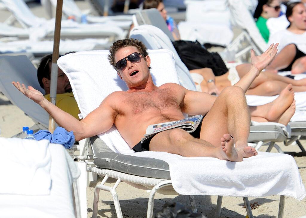 Billy Bush is seen relaxing on the beach with a friend during NATPE 2012 at the Fontainebleau Resort in Miami Beach