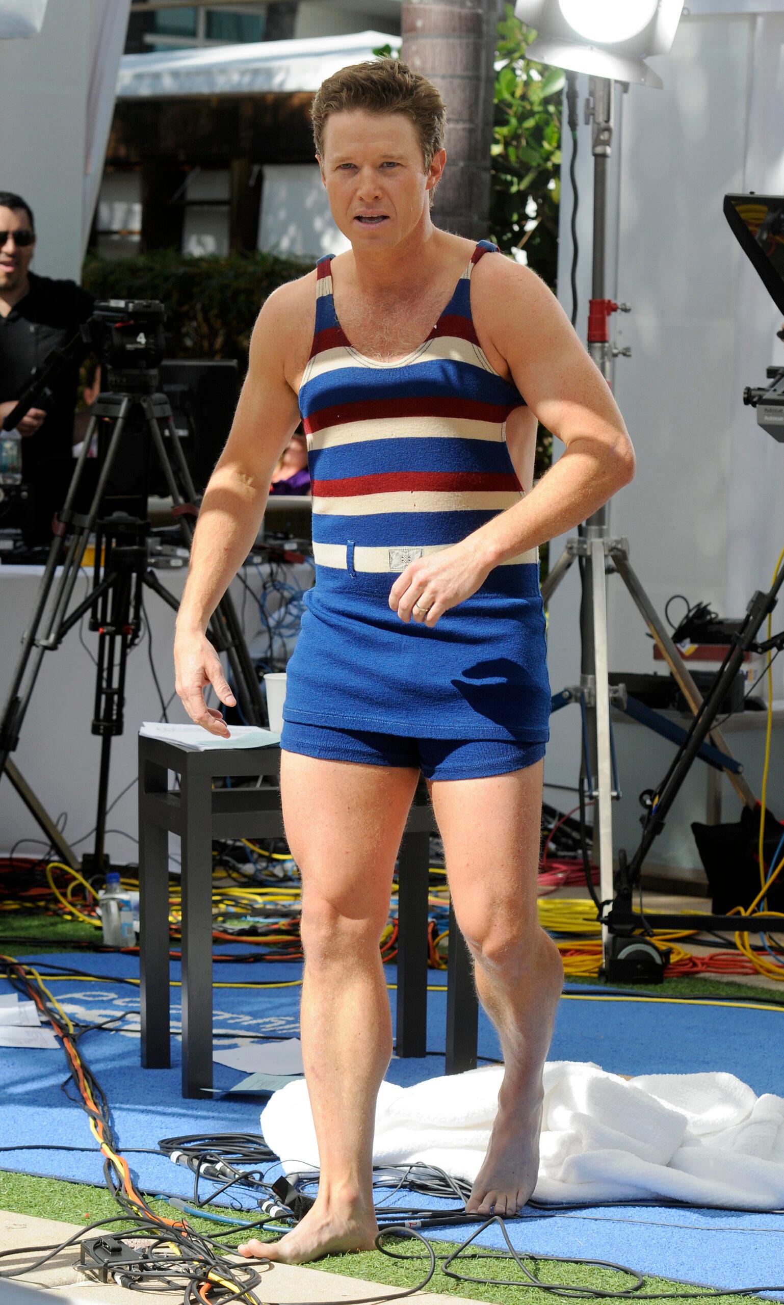 Billy Bush wears an old fashion bathing suit in the pool while taping Access Hollywood in Miami Beach