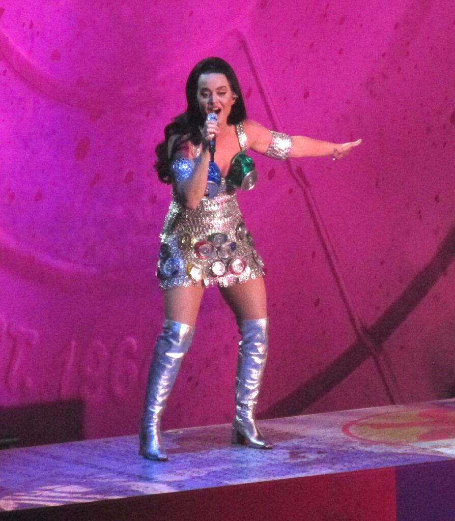 Katy Perry holds her stomach as she wears tightly fitting dress as she performs her last show until March in Las Vegas