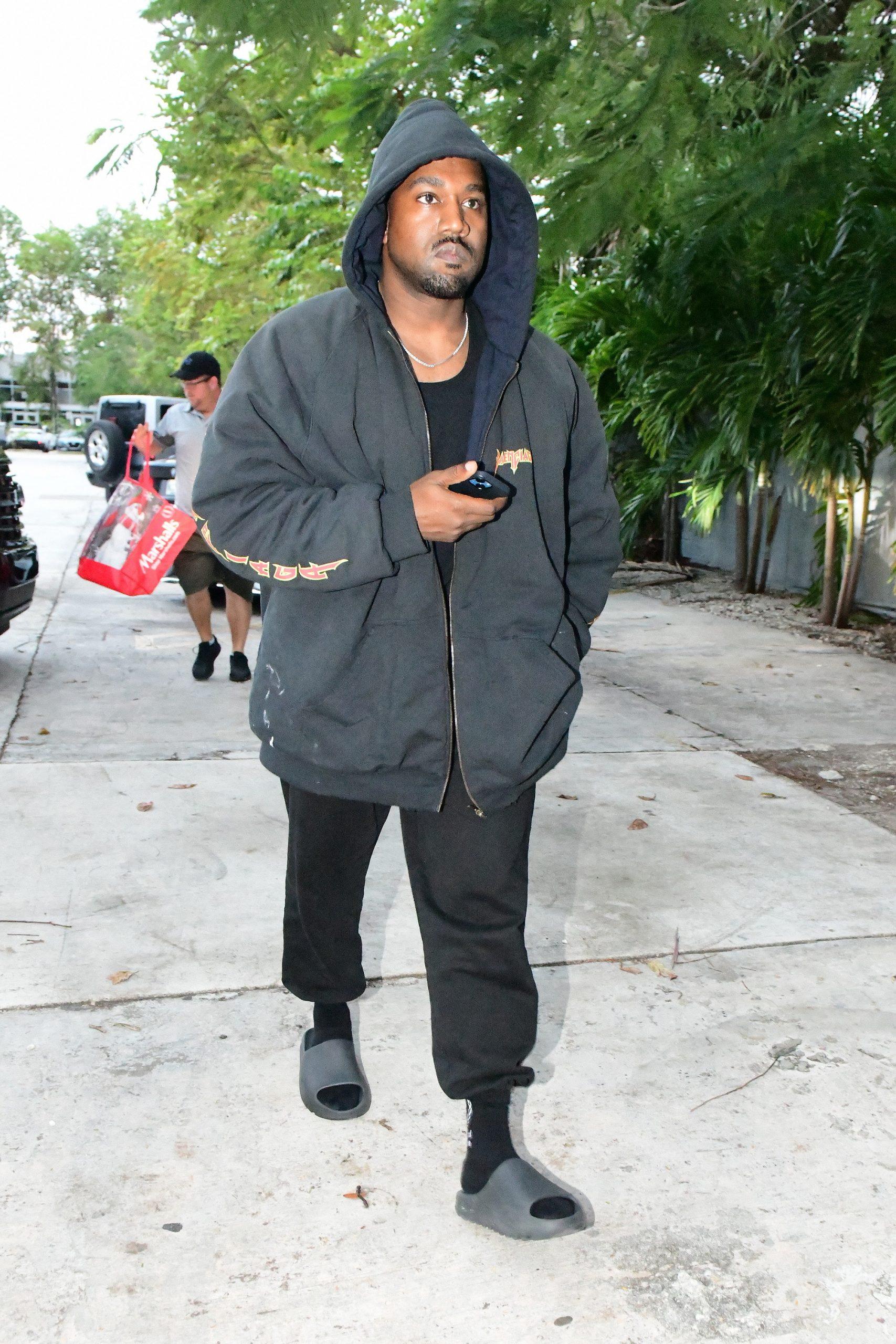 Kanye West is seen for the first time since becoming legally single as he hits up a tattoo shop in Miami