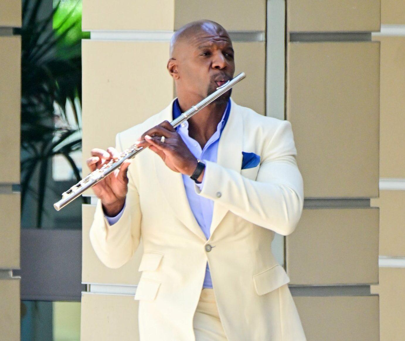 Terry Crews has the time of his life as he plays the flute while filming a scene for America's Got Talent in Pasadena