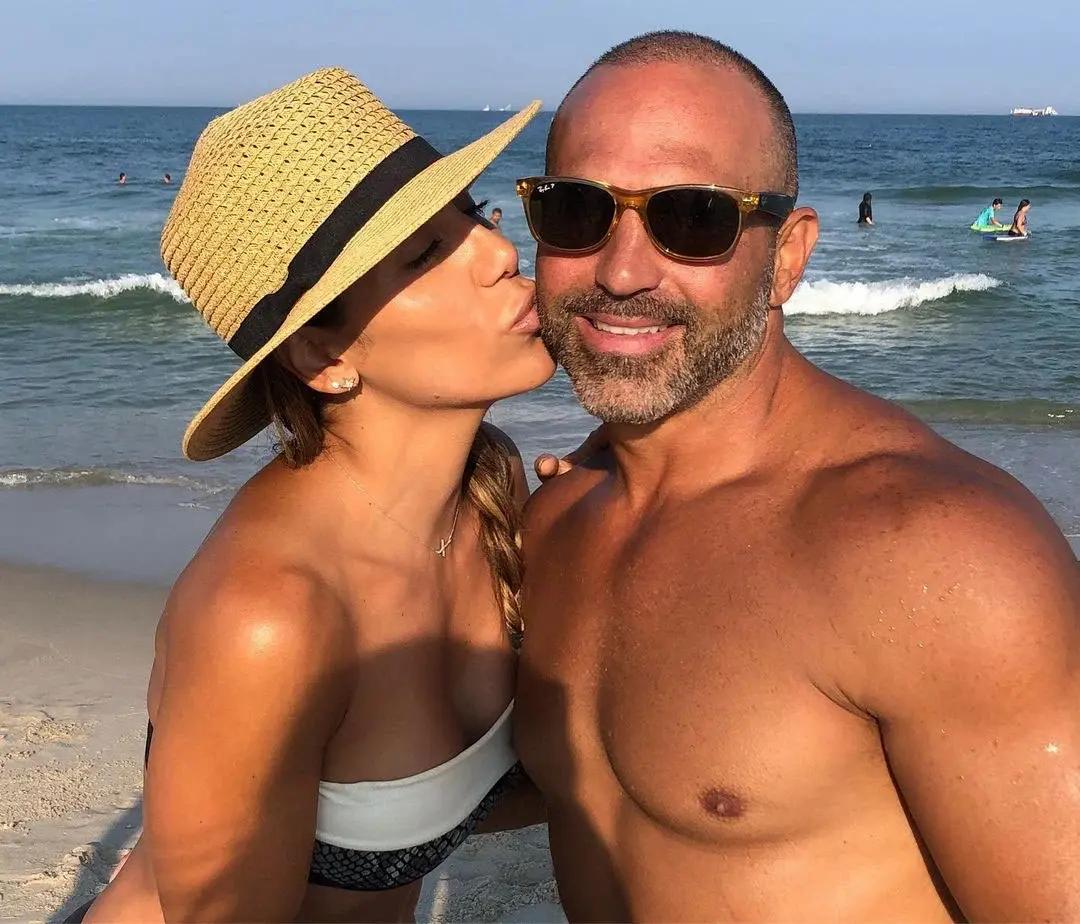 girl kissing man on beach