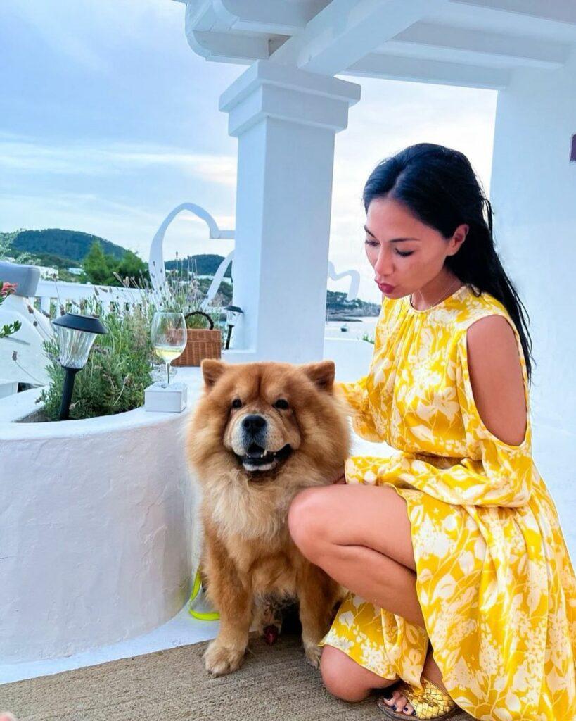 Nicole Scherzinger petting a dog.