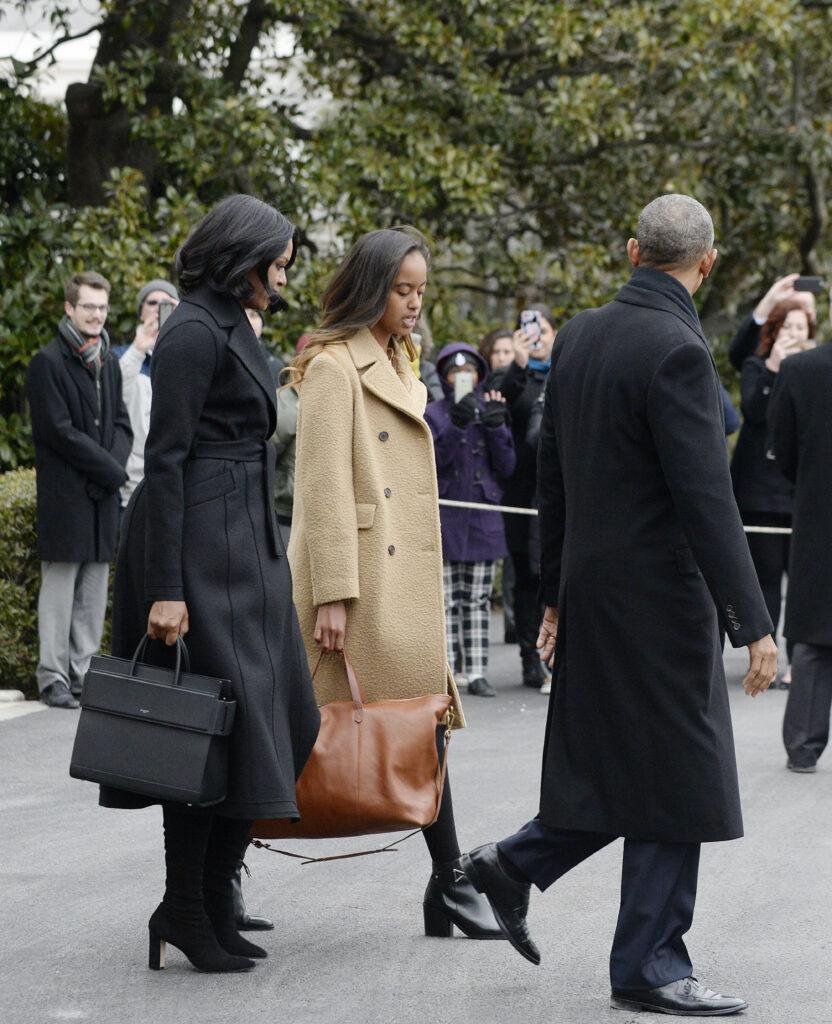 United States President Barack Obama with First Lady Michelle Obama and daughter Malia walk on the South Lawn towards marine One to depart the White House in Washington, DC. 10 Jan 2017 Pictured: Michelle Obama, Malia Obama, Barack Obama. Photo credit: ZUMA Press / MEGA TheMegaAgency.com +1 888 505 6342 (Mega Agency TagID: MEGA10568_003.jpg) [Photo via Mega Agency]