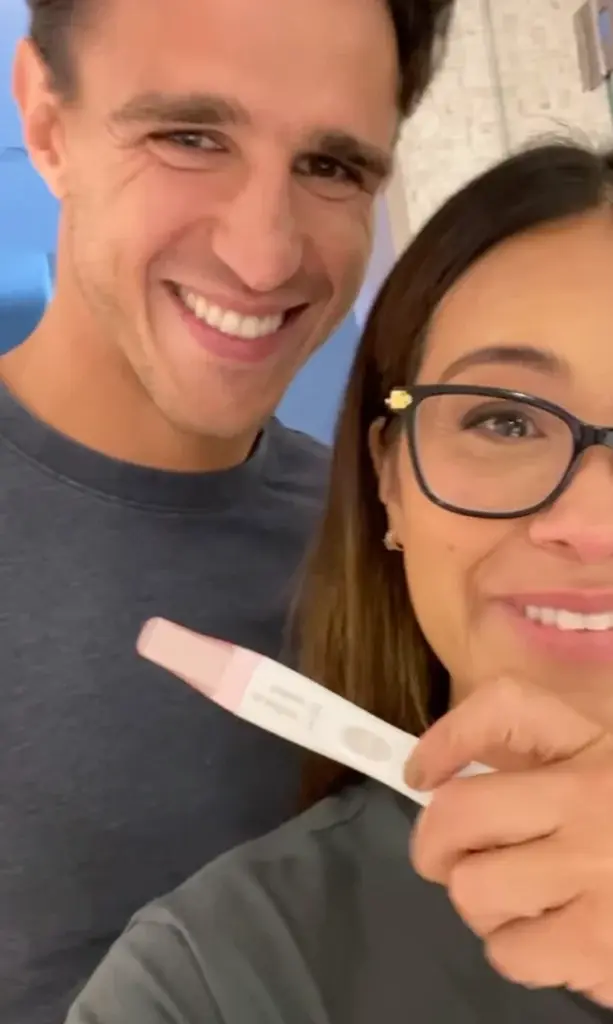 woman holding a positive pregnancy test