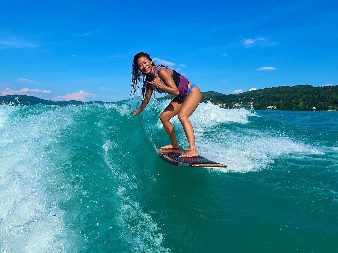 Nicole Scherzinger in bikini rides the waves.