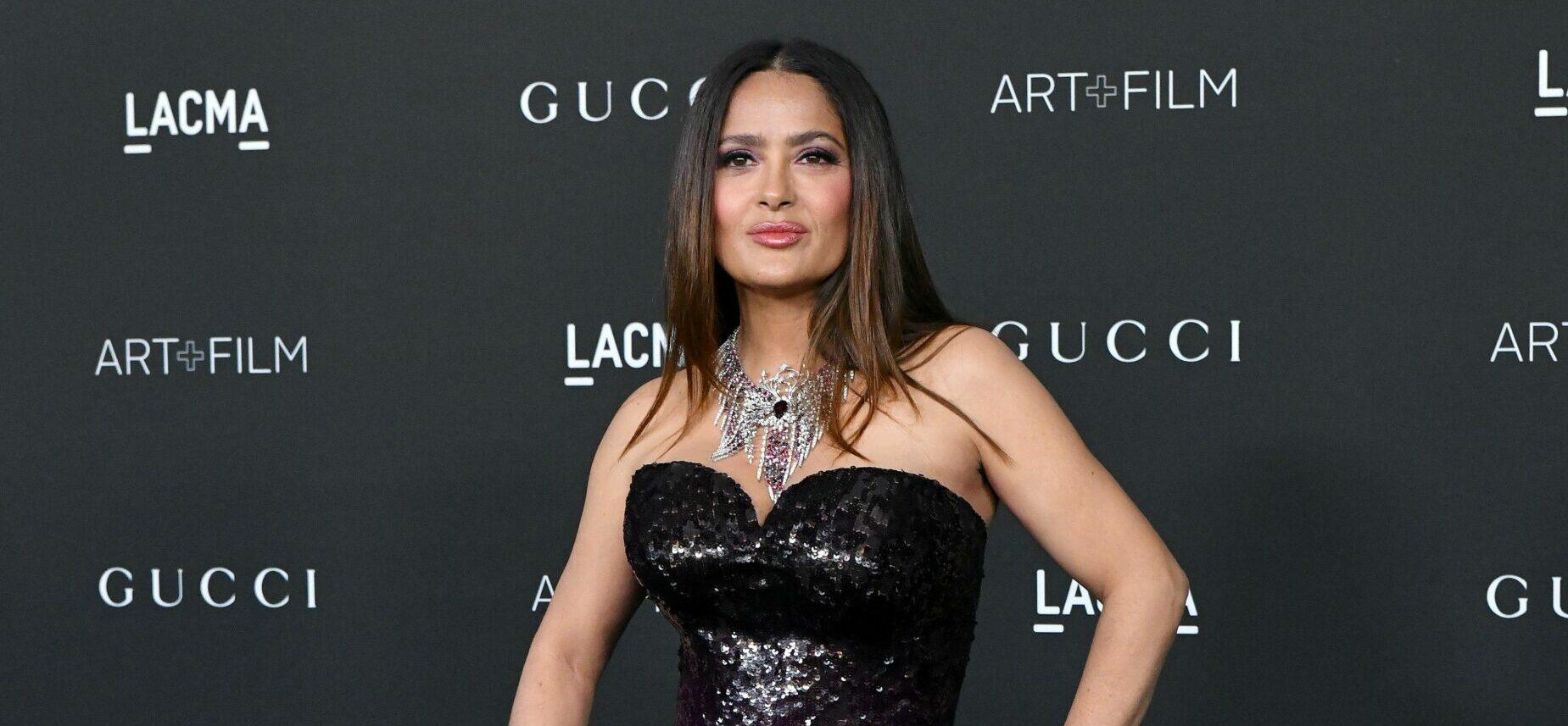 Salma Hayek Wades Through The Ocean In Her Plunging Blue Swimsuit