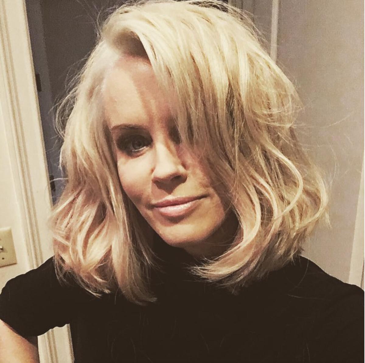 Jenny McCarthy taking a selfie in a black shirt