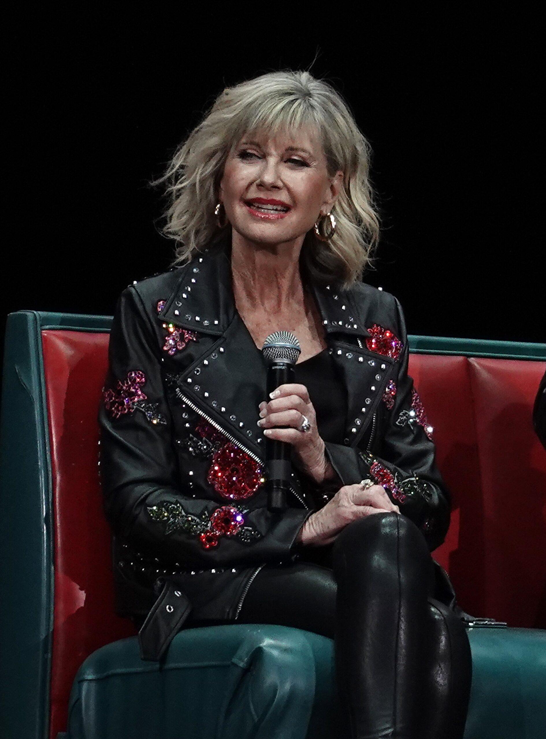 John Travolta and Olivia Newton John recreate their iconic Grease characters in full costume at the Meet N Grease sing-a-long in West Palm Beach