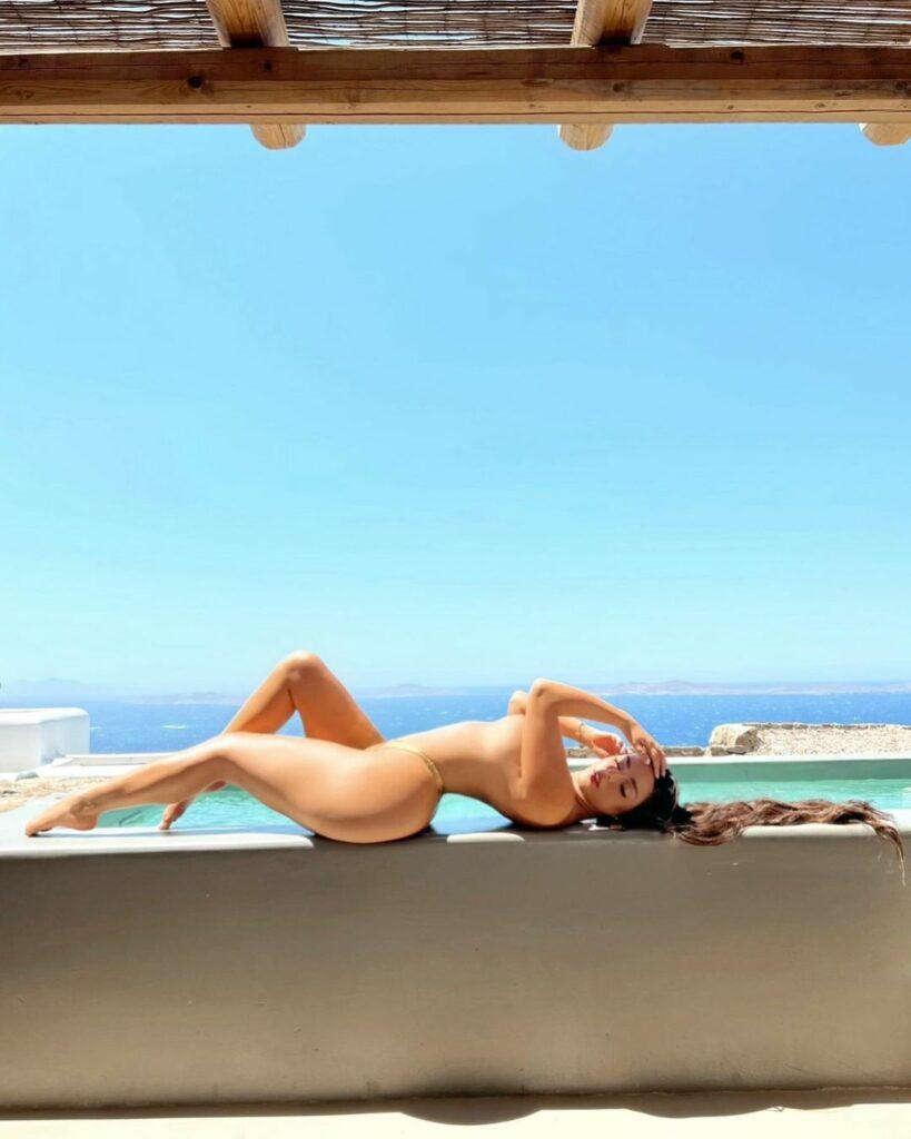 Demi Rose poses for the camera.