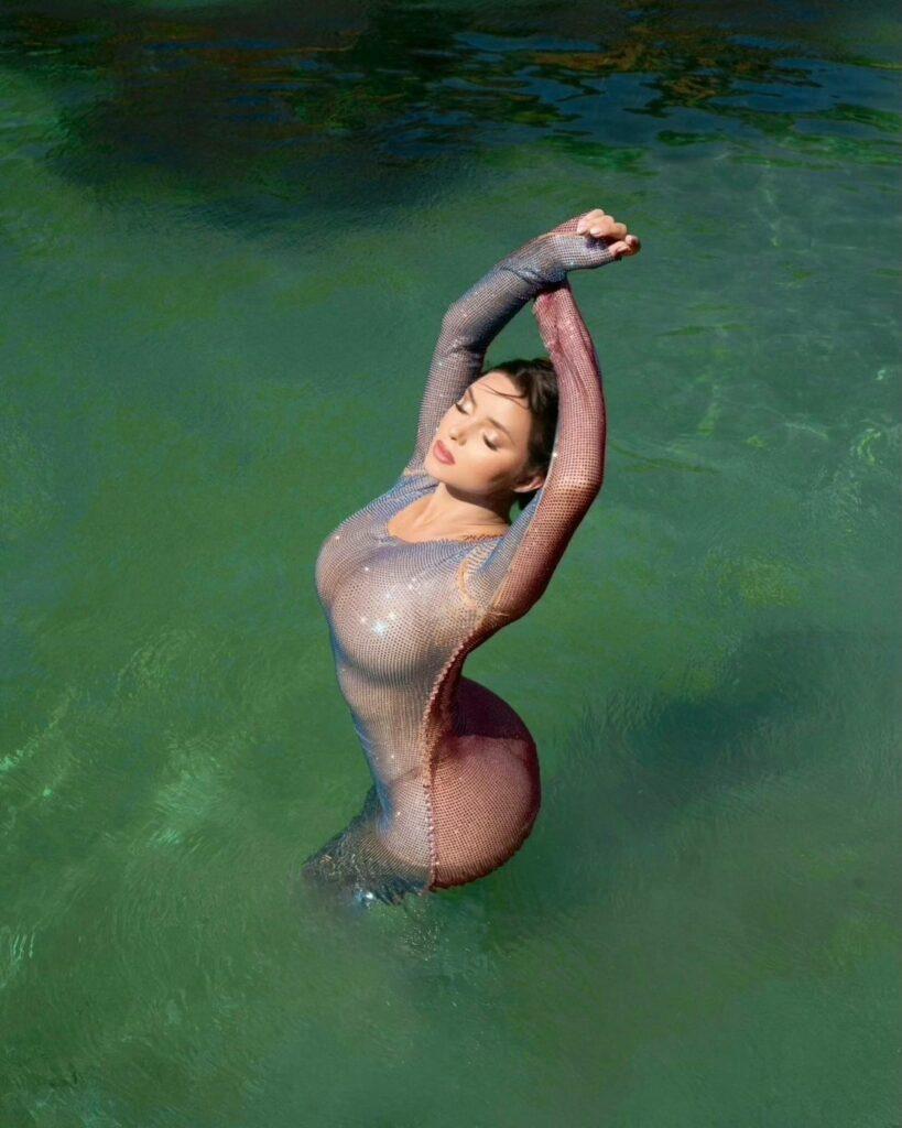 Demi Rose standing in the middle of the lake.