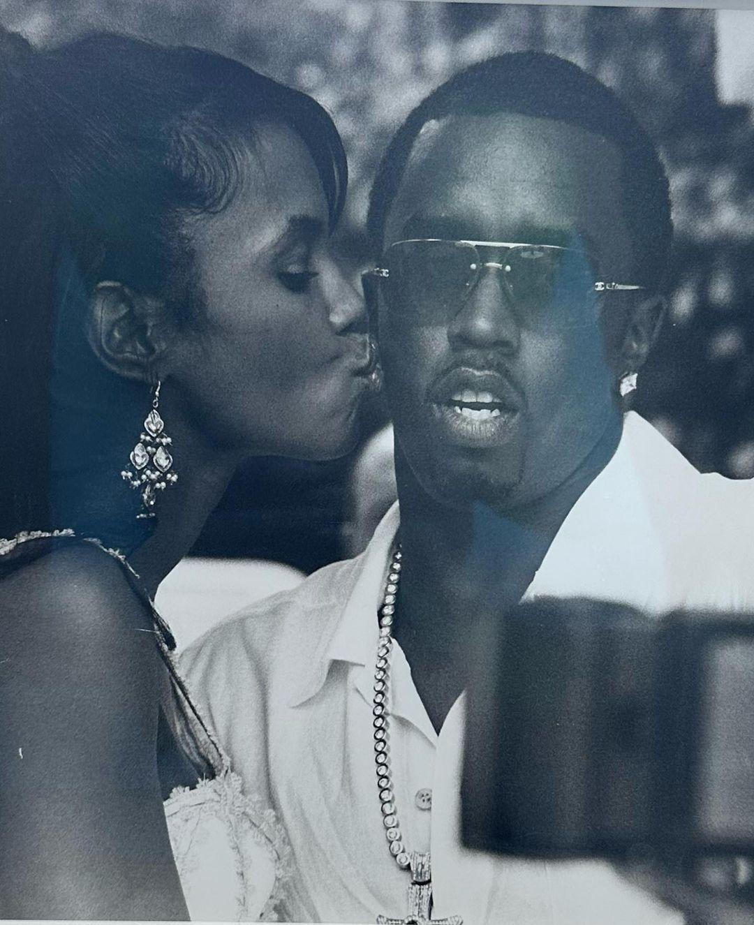 Late Kim Porter giving Diddy a kiss on the cheek