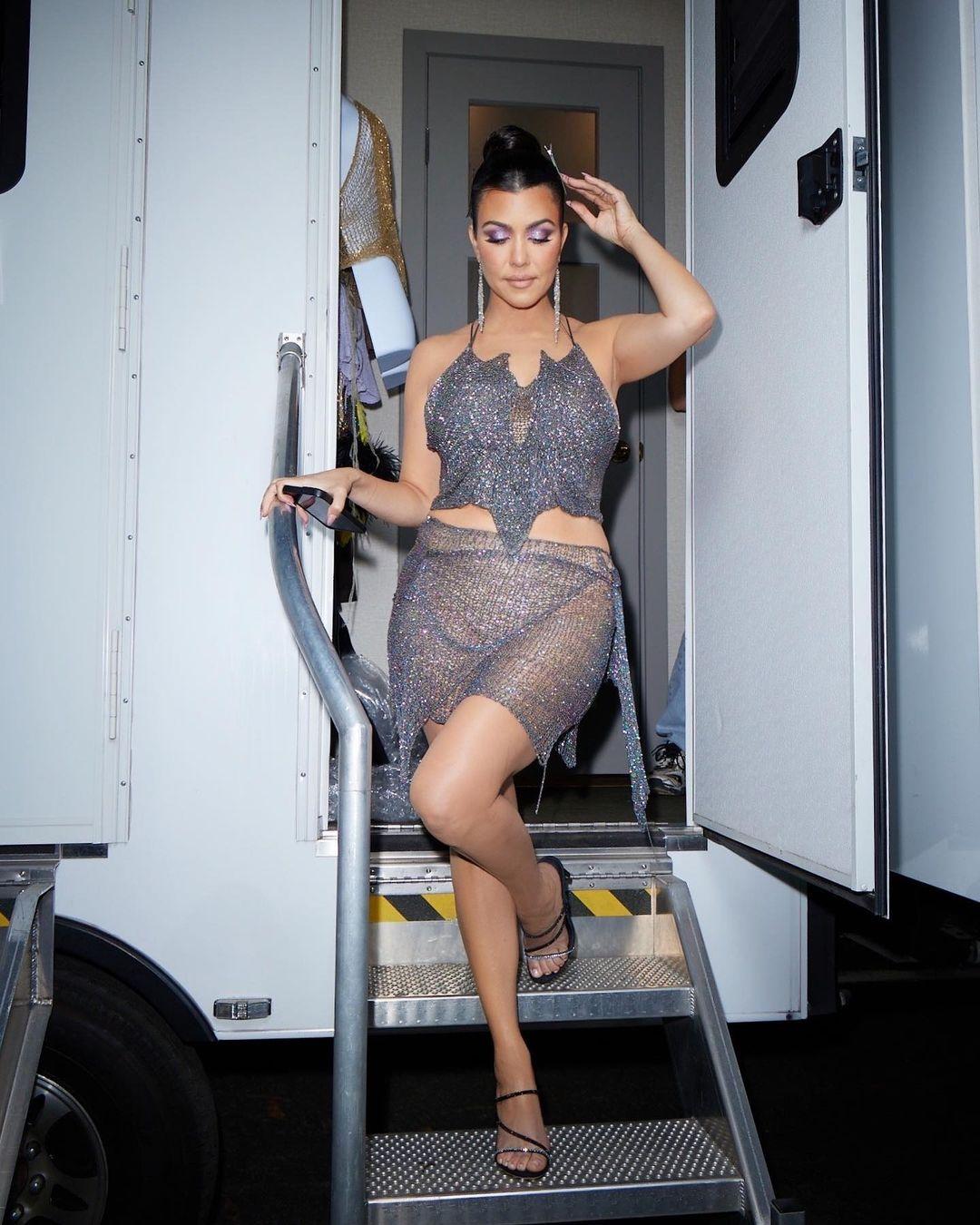 Kim Kardashian shows off her bare butt in pink thong bodysuit after  Kourtney's wild wedding weekend