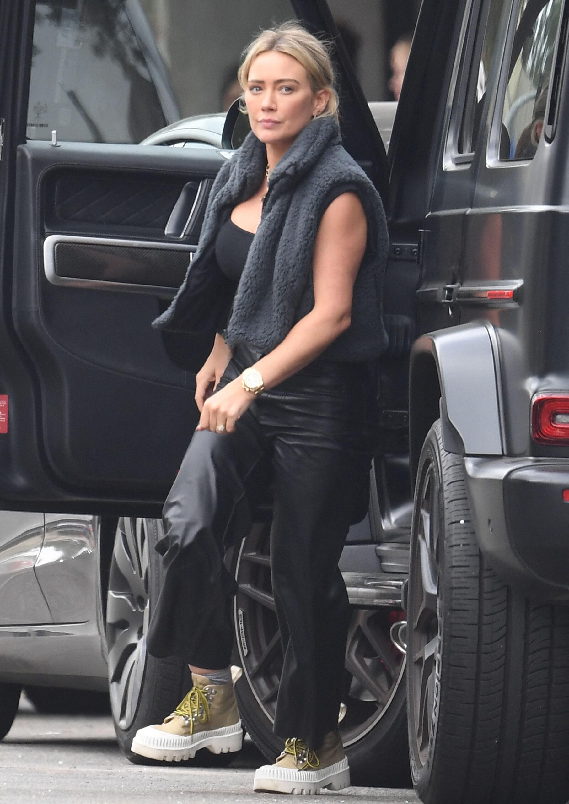 Hilary Duff wears tight black leather pants while picking up lunch in L A