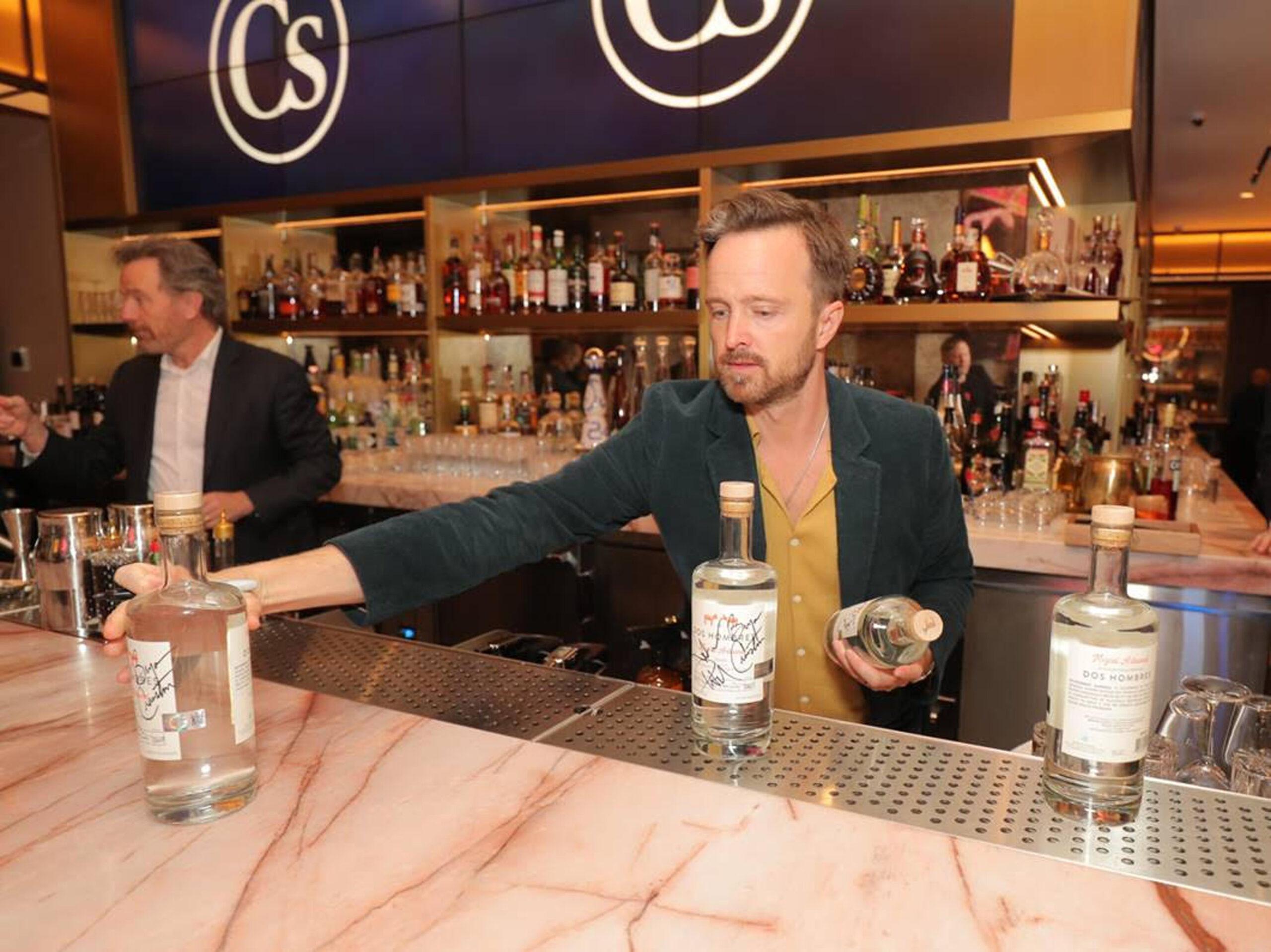 Breaking Bad stars Bryan Cranston and Aaron Paul serve their Dos Hombres mezcal at Resorts World Las Vegas