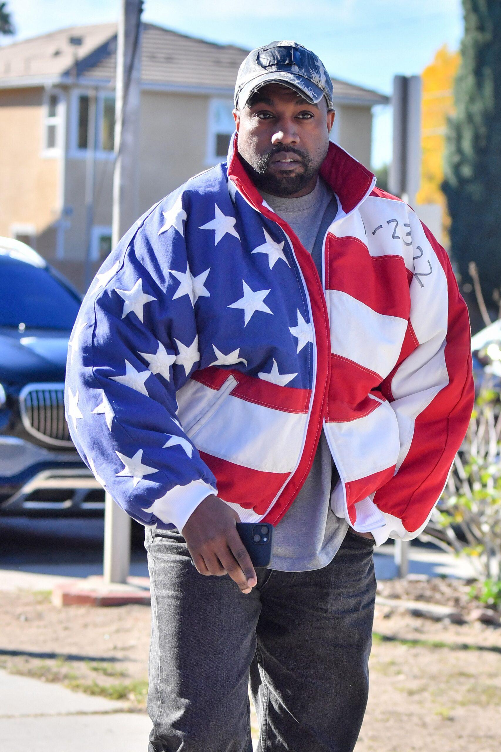 Kanye West leaving his office in a red and blue checkered jacket