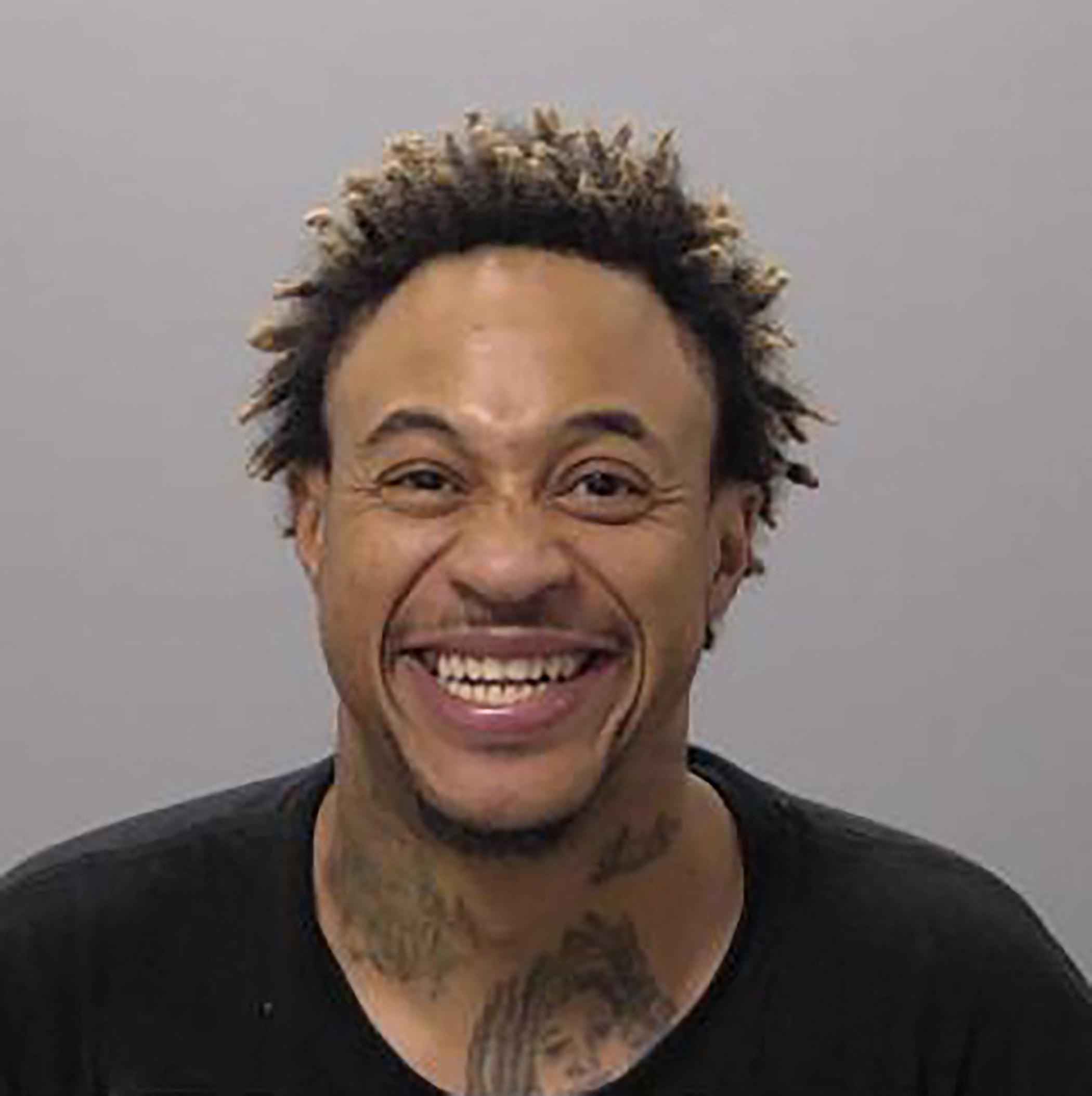 Thats So Raven star Orlando Brown grins after being arrested on domestic violence charge.